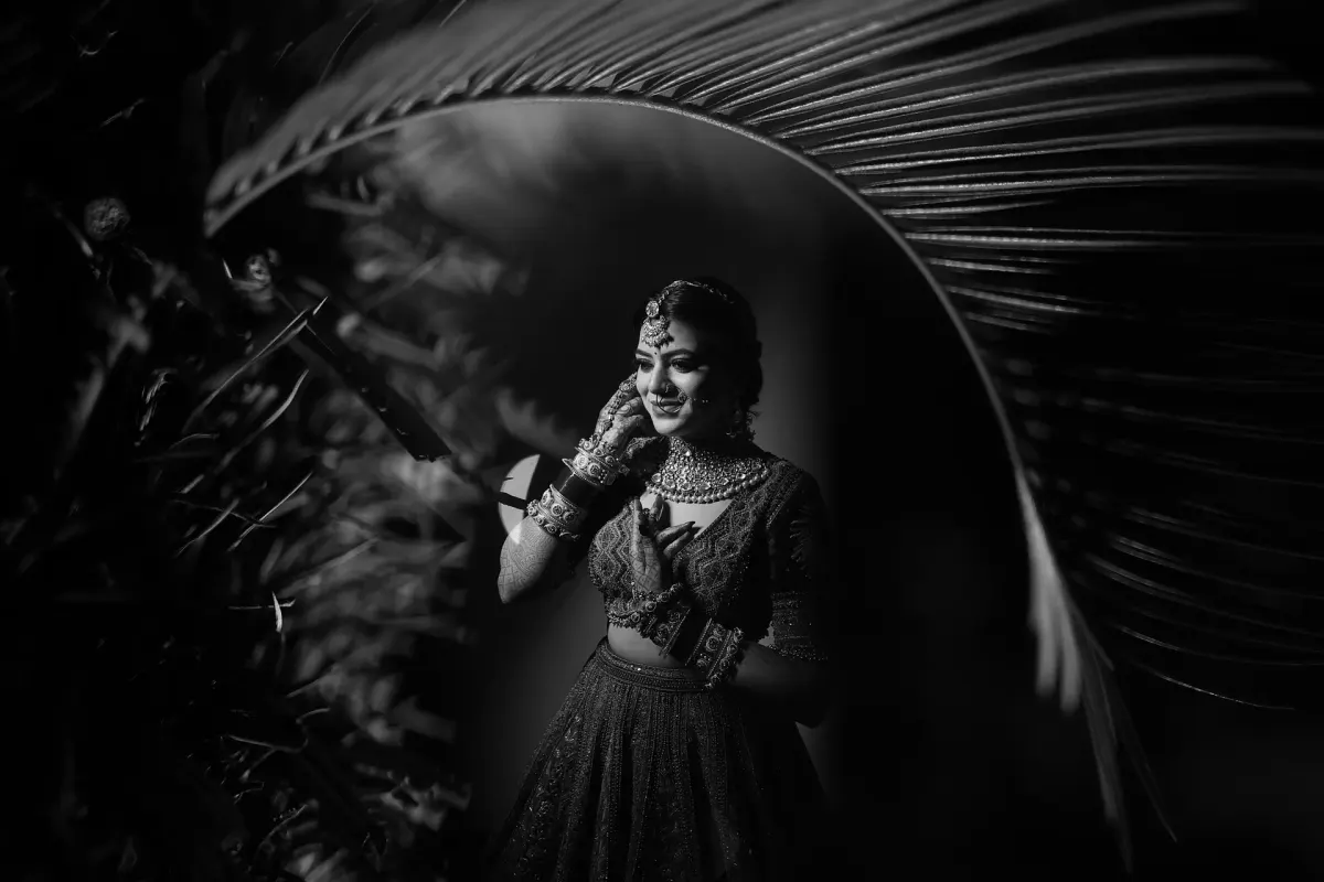 Monochrome Bridal Glance Framed by Palms